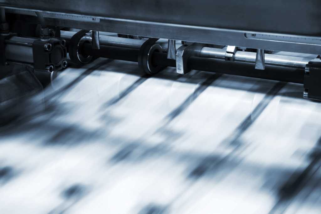High-speed commercial printing press producing printed materials