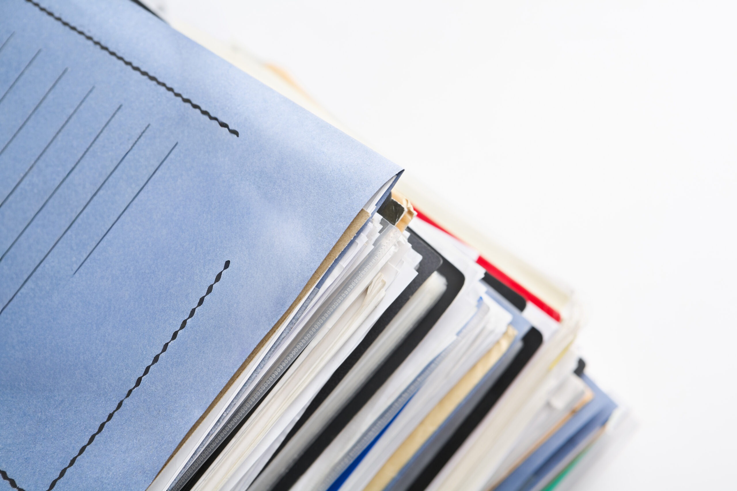Stack of organized paper files and document folders