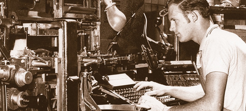 Vintage printer operating an early printing press in print shop